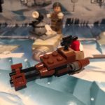 LEGO micro-build of an Imperial Speeder Bike mostly done in brown. The 2014 version is themed as a sort of Santa's sleigh with a sack on the back holding a red present with a white bow. It also has a small black pistol mounted on the rear for some inexplicable reason. Perhaps to shoot toy thieves!