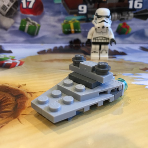 LEGO micro build of an Imperial Star Destroyer mostly in light gray. The 2015 version has three transparent light blue engines at the rear and the characteristic wide bridge tower complete with twin shield generator domes, but the tip is stubby.