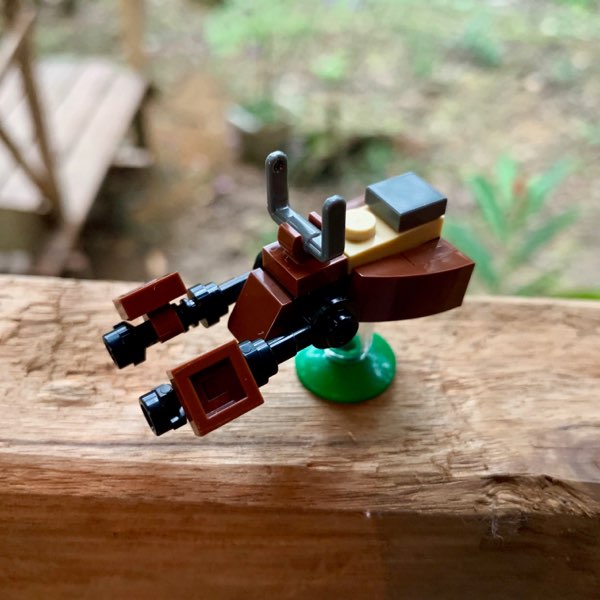 LEGO micro-build of an Imperial Speeder Bike mostly done in brown and black. The 2018 version included front steering vanes a transparent brick to make it hover and a small green dish to act as a stand and be a tiny part of the Endor forest floor.