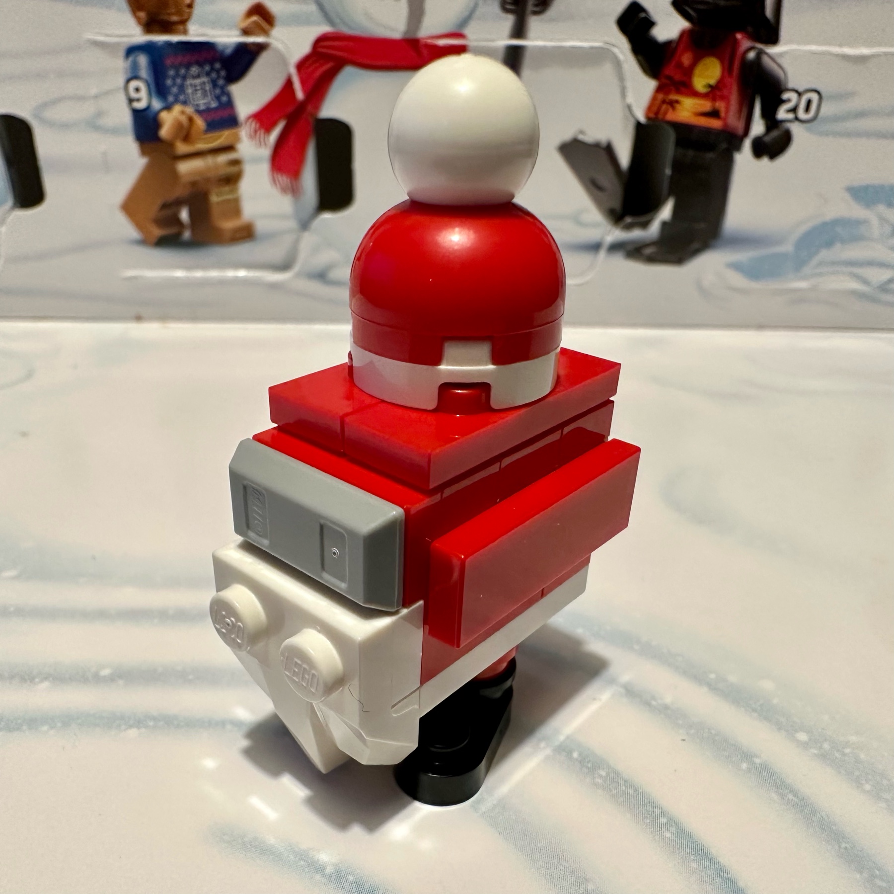LEGO gonk droid in red and white with a Santa hat, white beard, and black boots