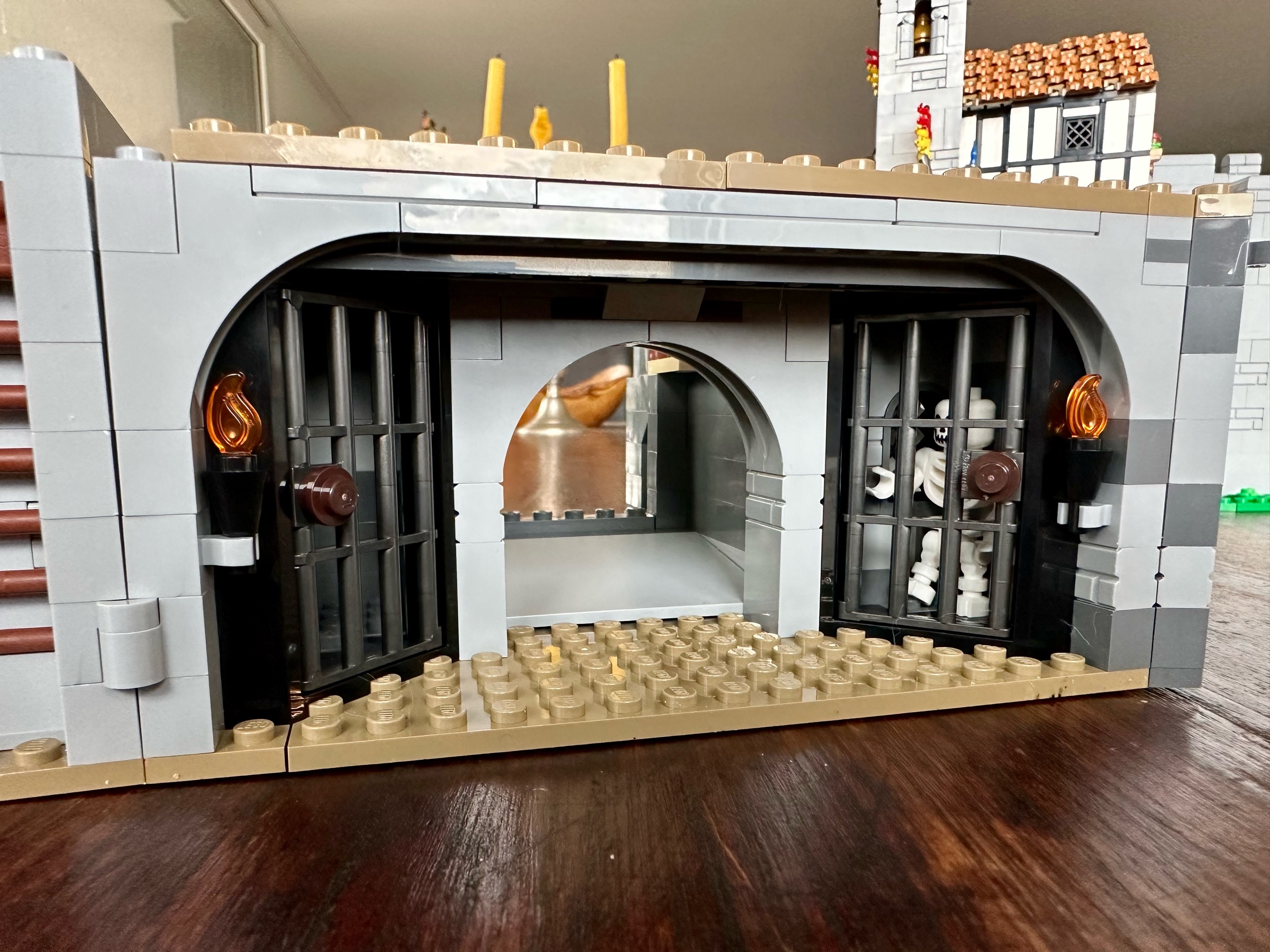 LEGO dungeon with two jail cells. The right cell holds a skeleton.
