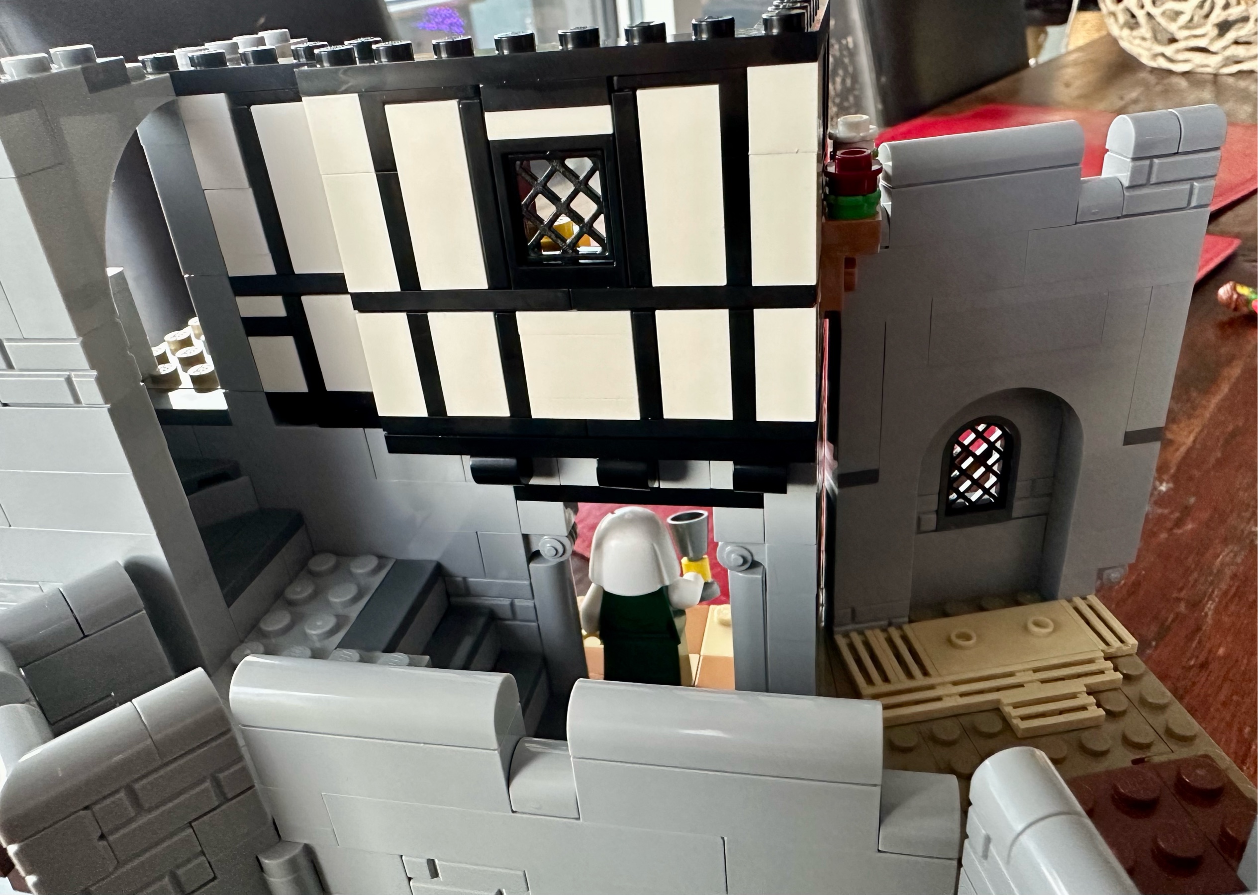 Exterior view of LEGO castle showing white plaster walls trimmed with black wood.