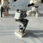 LEGO micro-build mostly in light gray of an Imperial AT-ST, All-Terrain Scout Transport, a two-legged mechanical walker with guns.