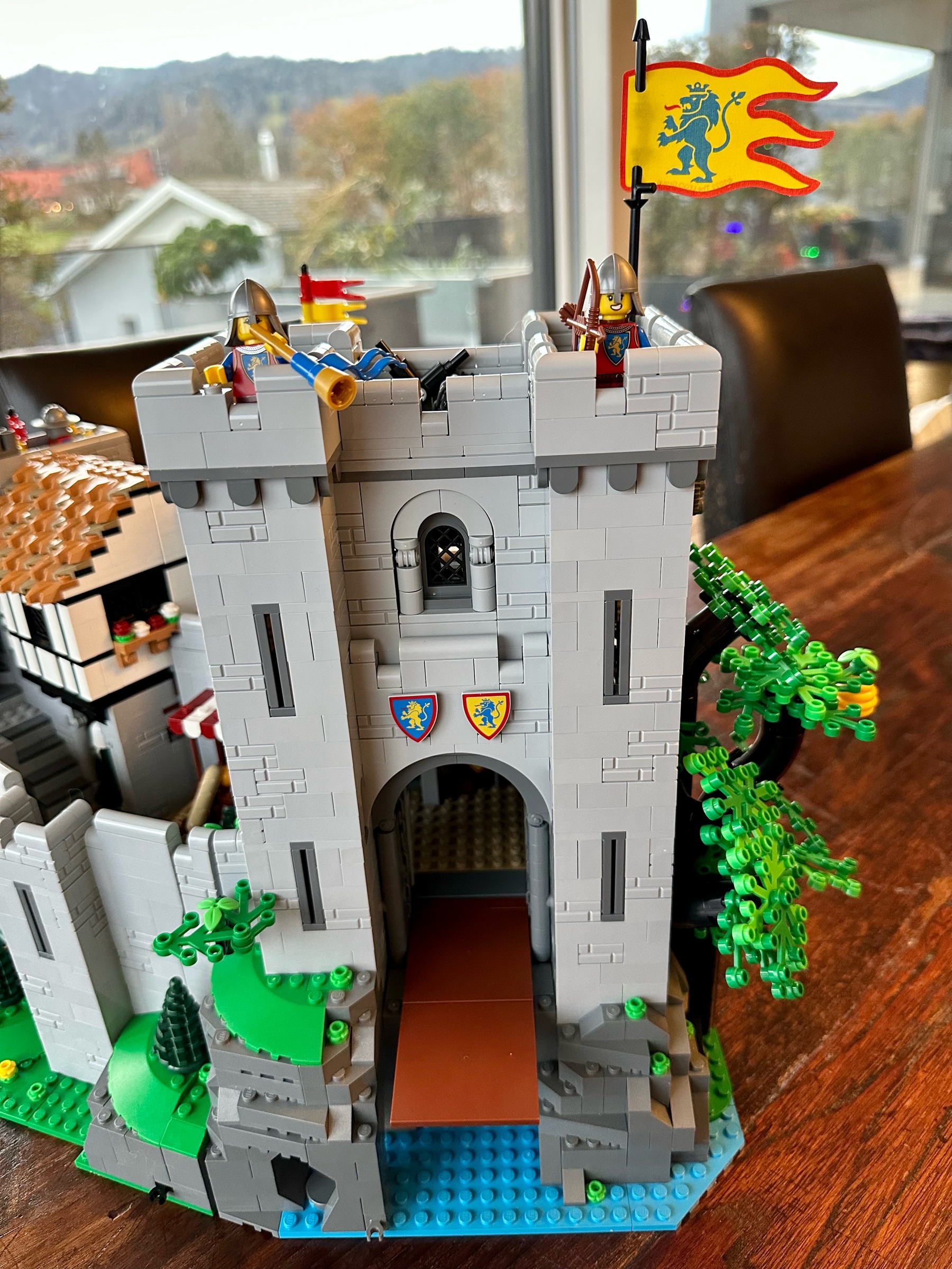 LEGO castle with two guards on top. The left guard is blowing a trumpet.