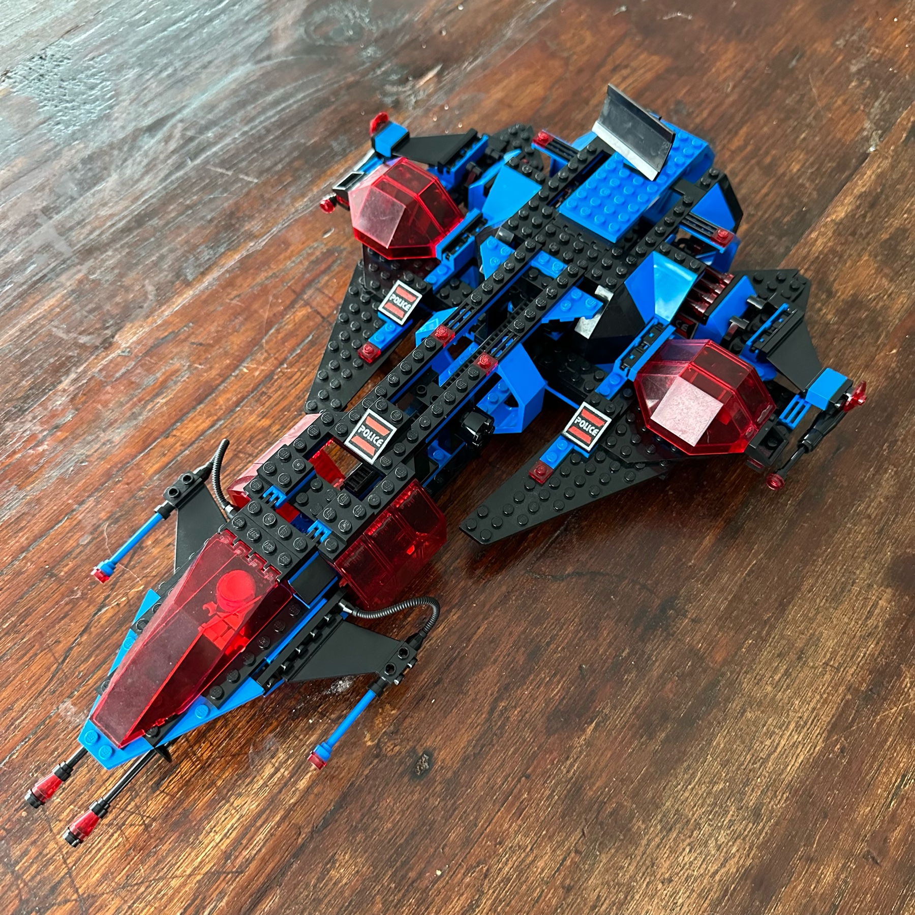LEGO spaceship in a blue, black, and transparent red color scheme.