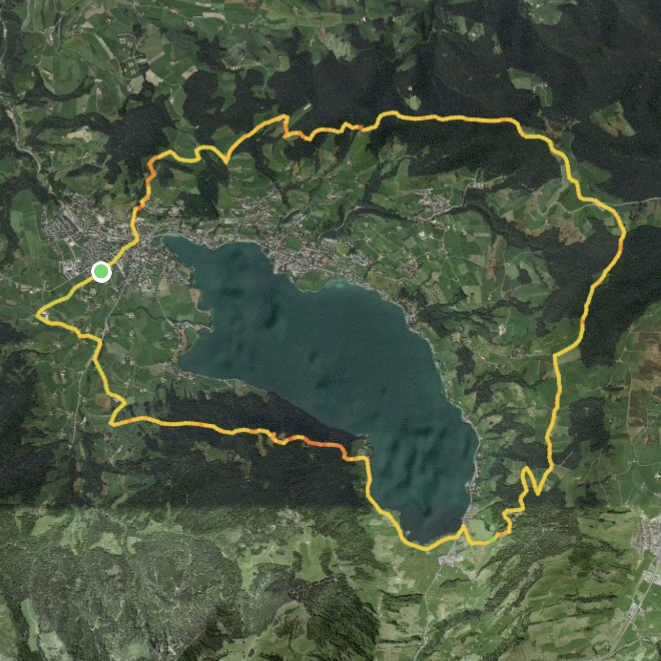 Satellite view showing a lake with a GPS track forming a loop around it.