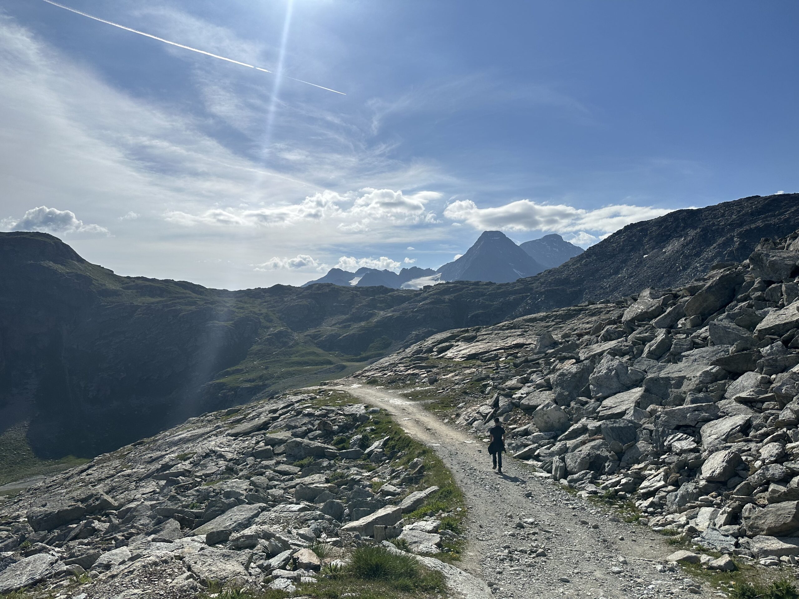 View of hiking trail across rocky alpine terrain.
