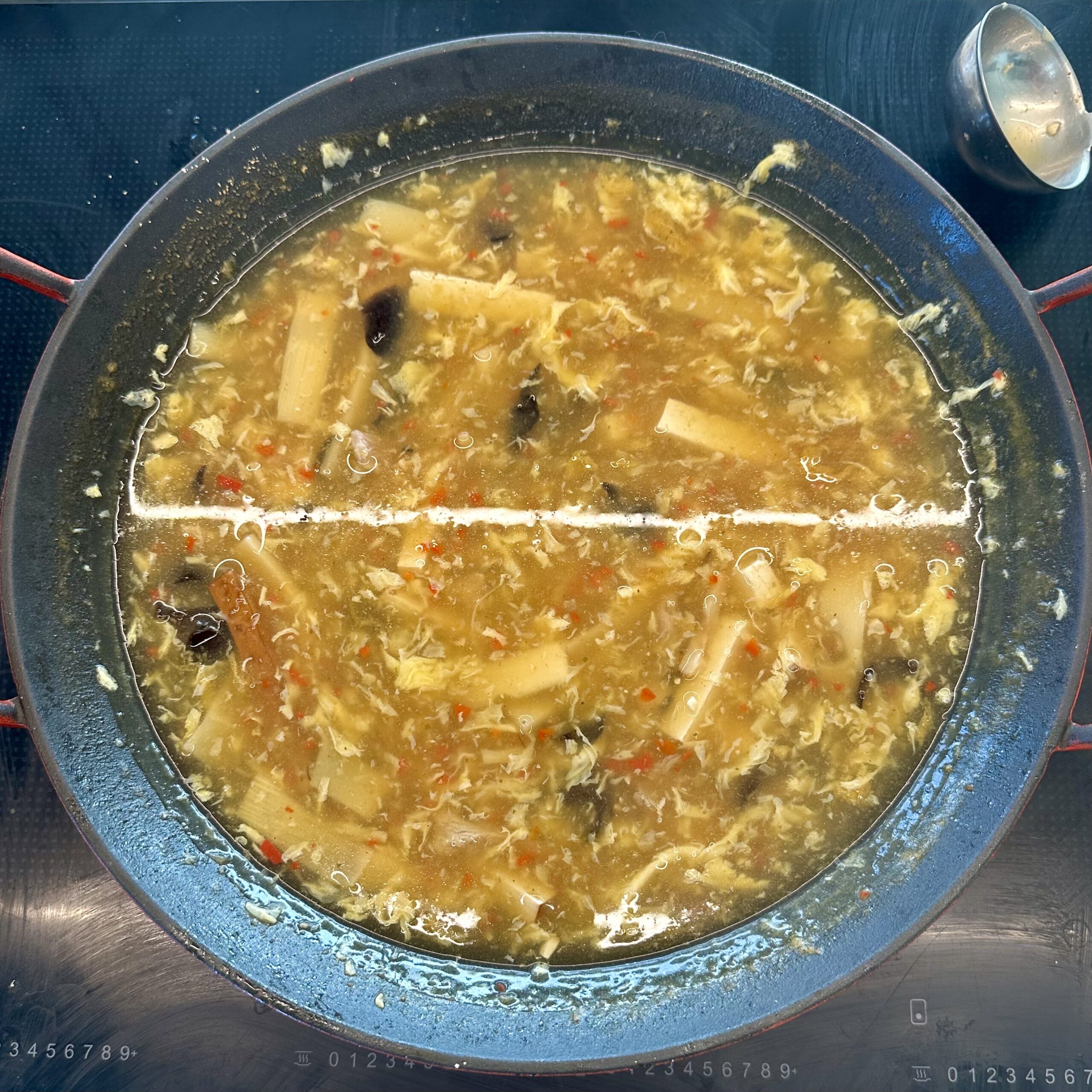 A wok full of Chinese Hot and Sour soup