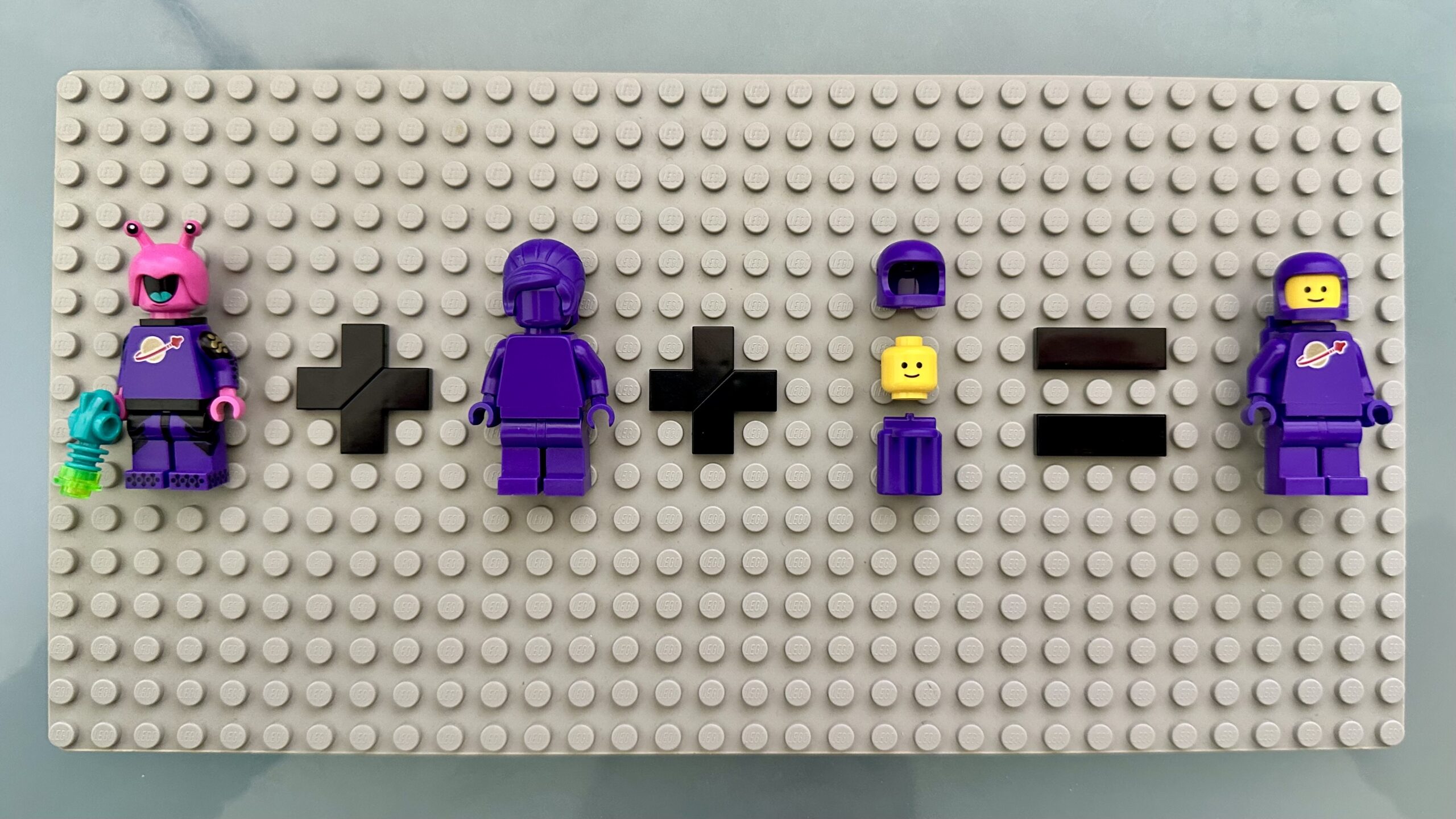 LEGO minifigure math: Series 22 Space alien + purple monocolor minifig + purple helmet, smiley face head, and purple air tanks = purple Classic Space minifig.