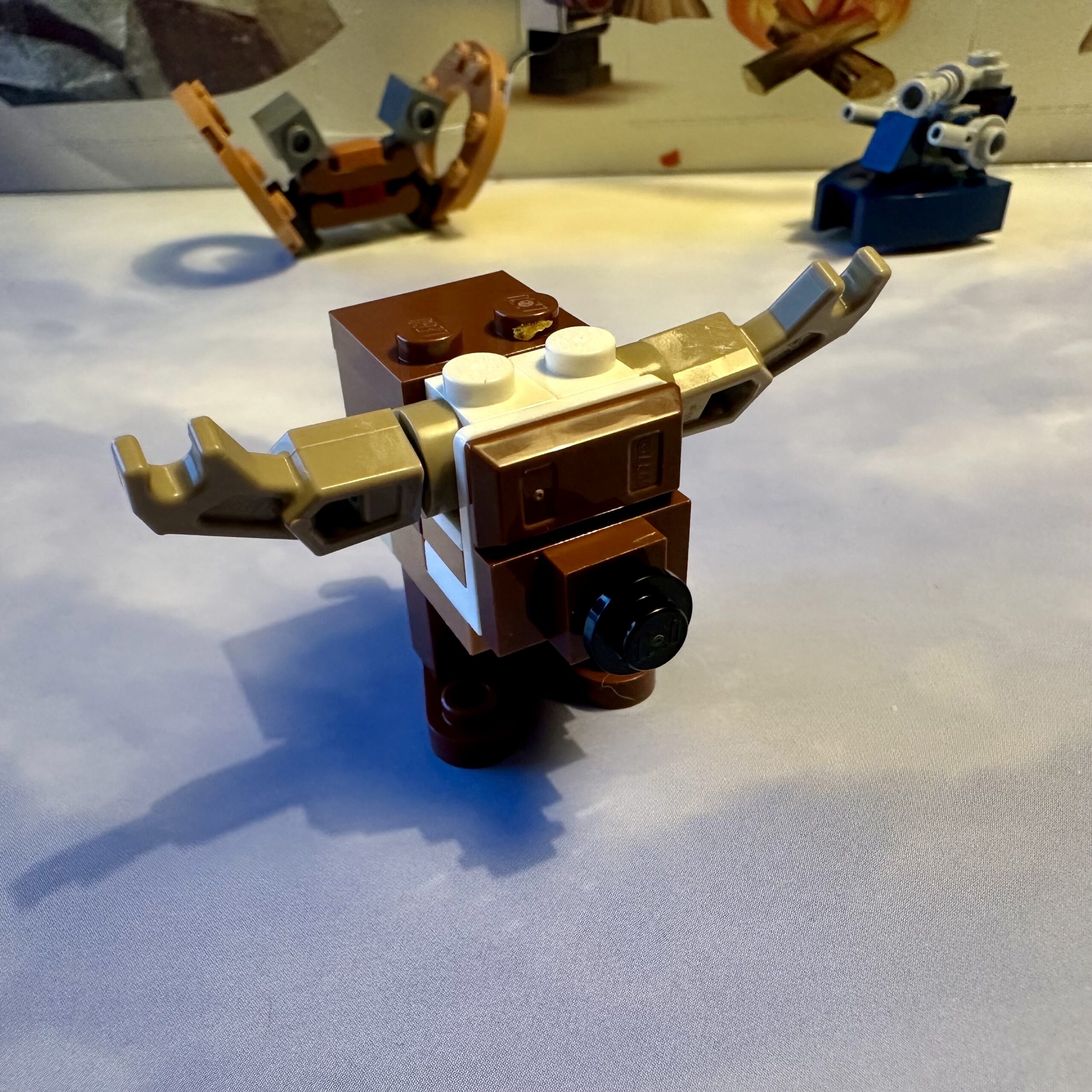 LEGO micro-build of a brown Star Wars GONK droid with tan antlers and a black nose.