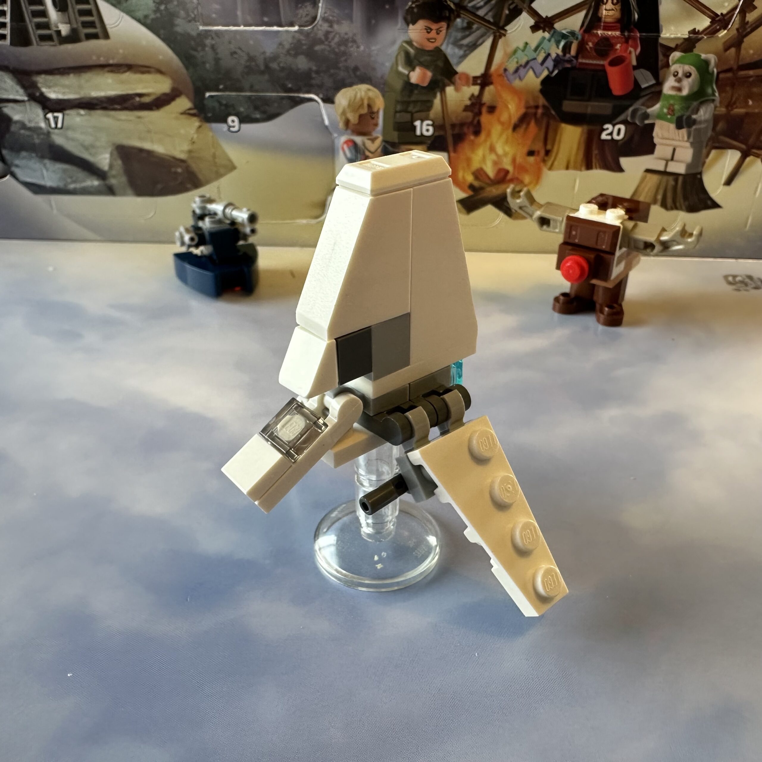 LEGO micro-build of an Imperial shuttle in white. It has a large vertical upper fin and two wings that angle down.