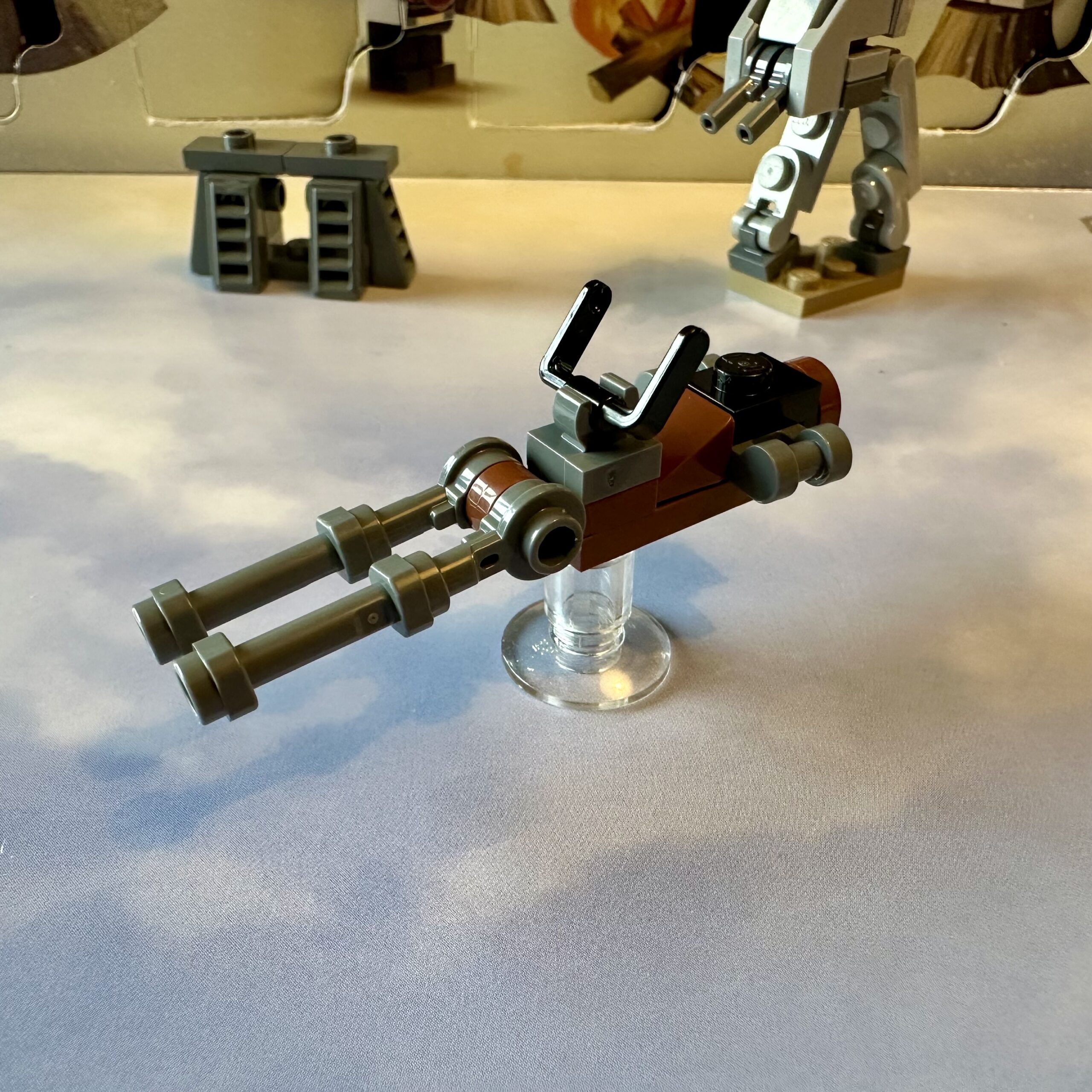 LEGO micro-build of an Imperial Speeder Bike mostly done in brown and dark gray. The 2023 version is longer and sleeker than the others but lacks the front steering vanes.