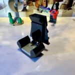 LEGO micro-build of Emperor Palpatine's throne with black arms and high back and a gray seat.