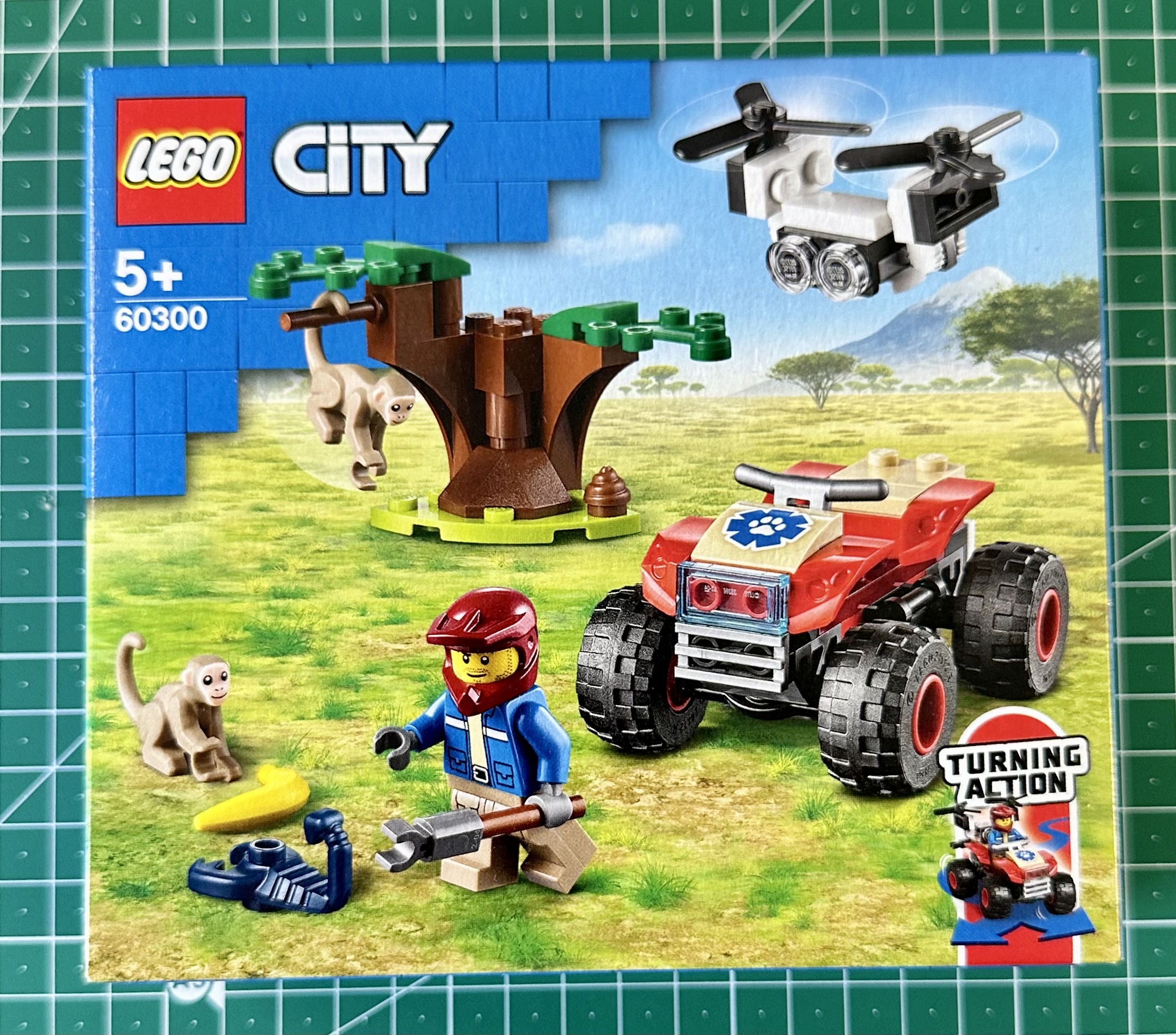 Box for LEGO City set 60300. Box depicts a 4WD vehicle, a flying drone, a minifigure, a tree, two monkeys, and a scorpion.