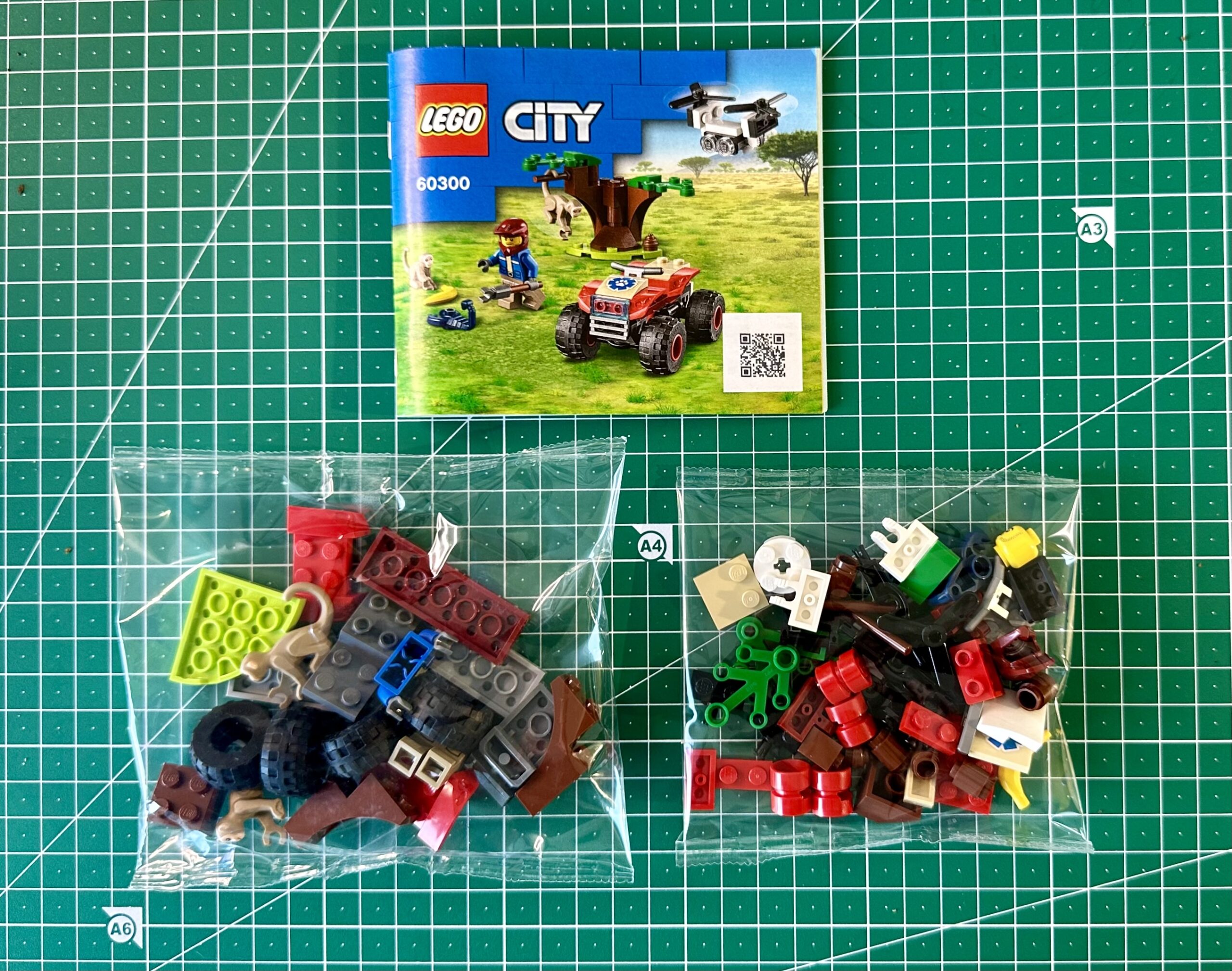 Instruction manual and two bags of LEGO pieces for LEGO City set 60300.