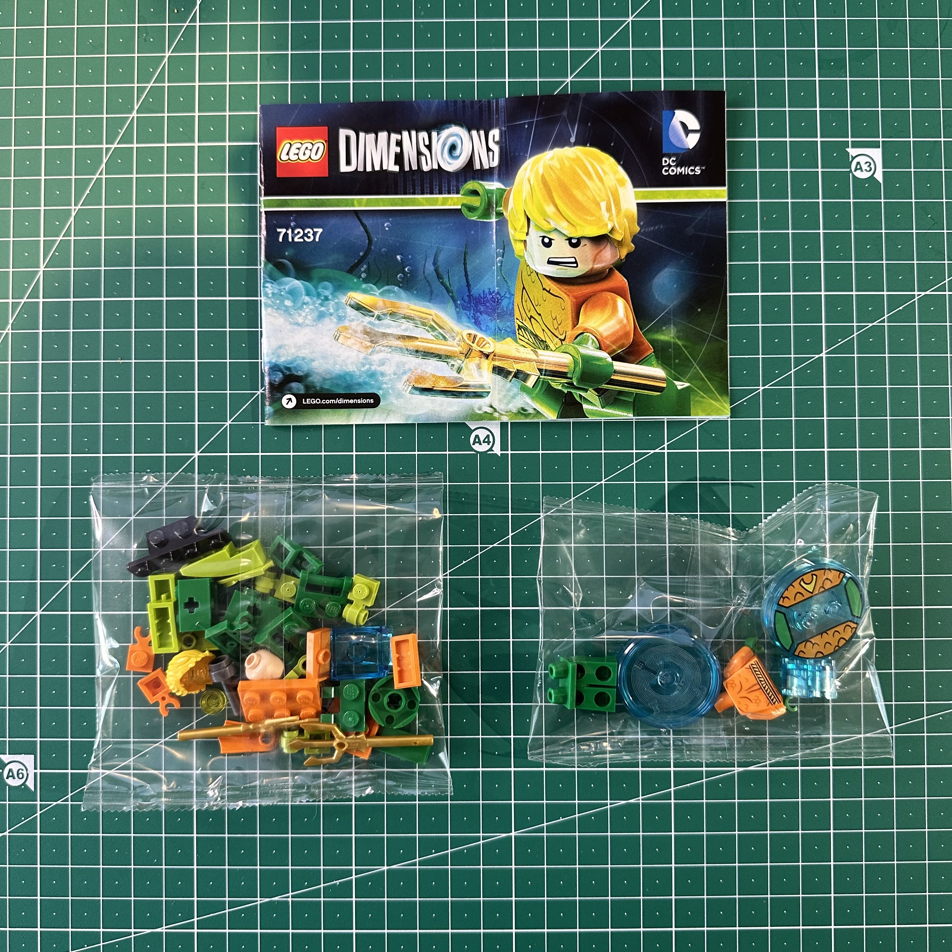 Instruction manual and two bags of LEGO pieces for LEGO Dimensions set 71237 Aquaman Fun Pack.